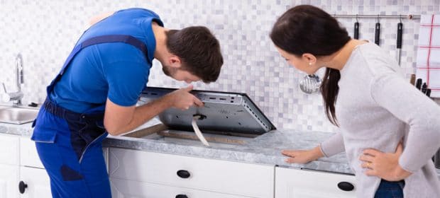 Technician Fixing Induction Hob with Problems