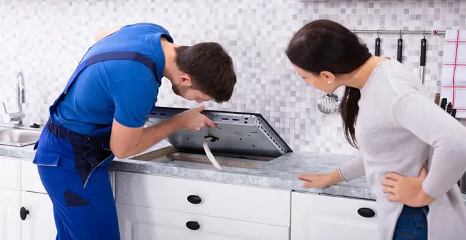 Technician Fixing Induction Hob with Problems